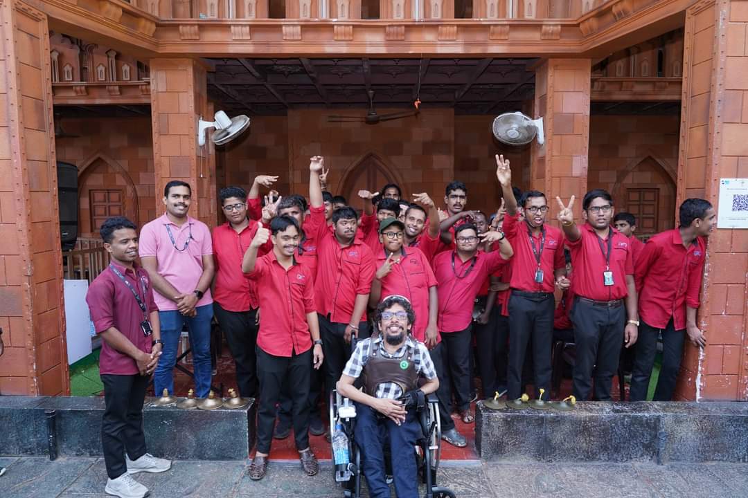 Davey Jose seated with the Centre for Differently Abled team in Kerala